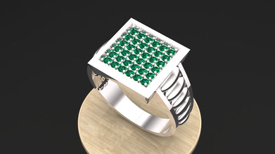 Men's handmade silver ring named Apex, featuring emerald green stones.