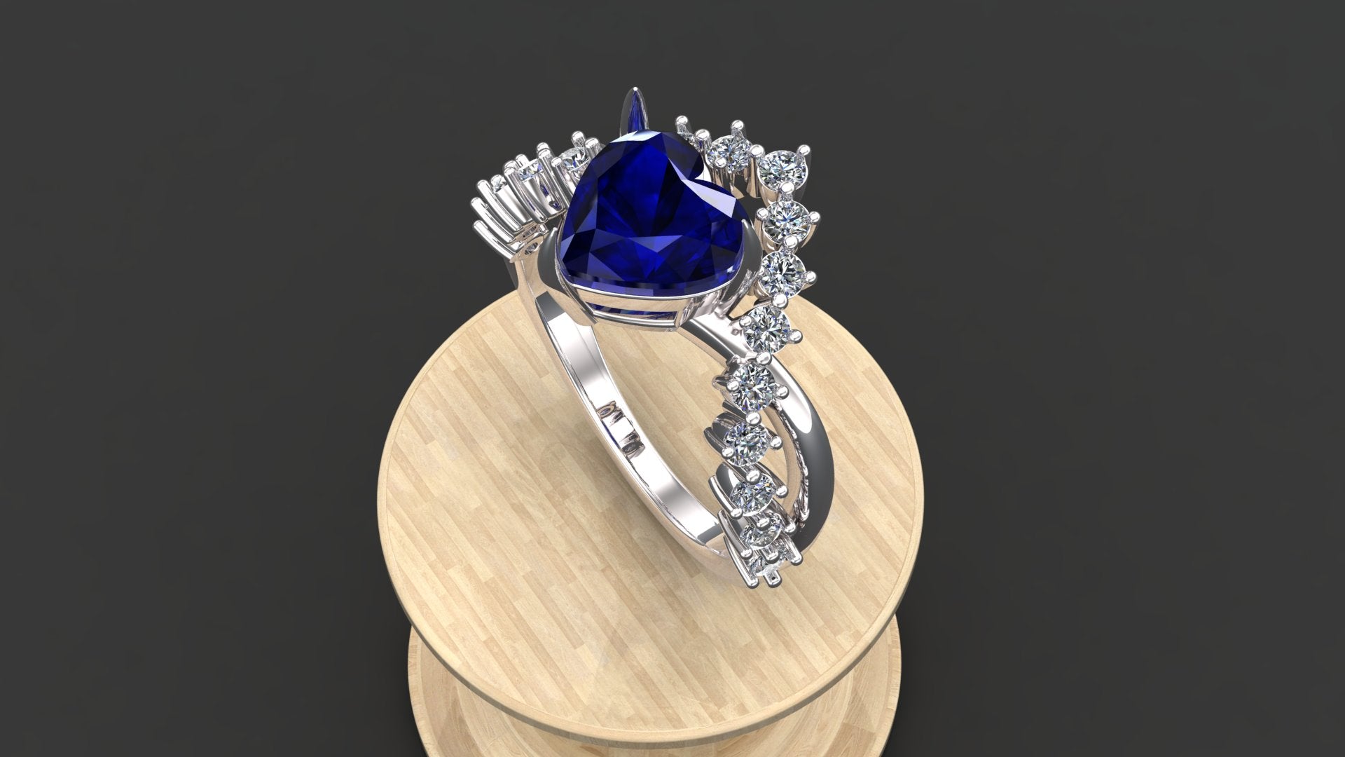 "Minzaari Jewels' Aziza ring with a royal sapphire blue heart-shaped stone."