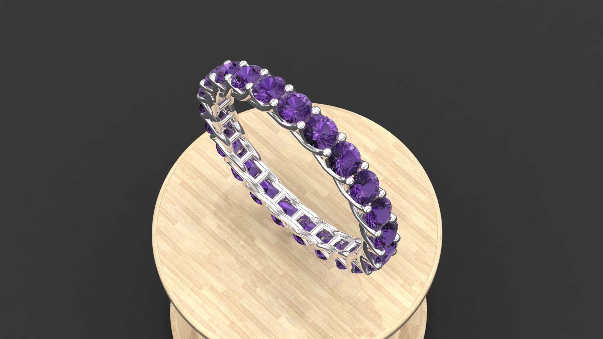 The "Amara" custom birthstone eternity wedding band shown with amethyst purple stones.