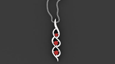 Minzaari Jewels' Kaia three-stone pendant with passionate ruby red gems.