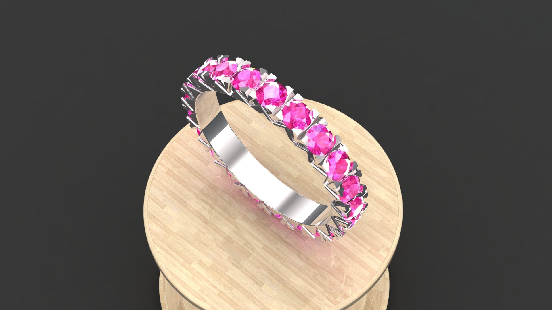 "Elegant Elara anniversary ring with pink tourmaline in a half-eternity silver setting."