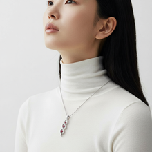 Minzaari Jewels' Kaia three-stone pendant with passionate ruby red gems.